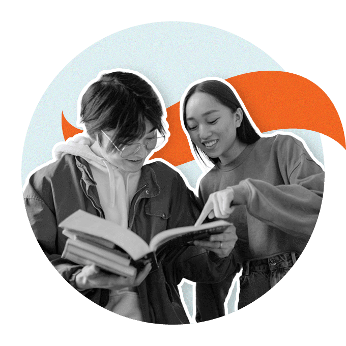 Two students reading a book together